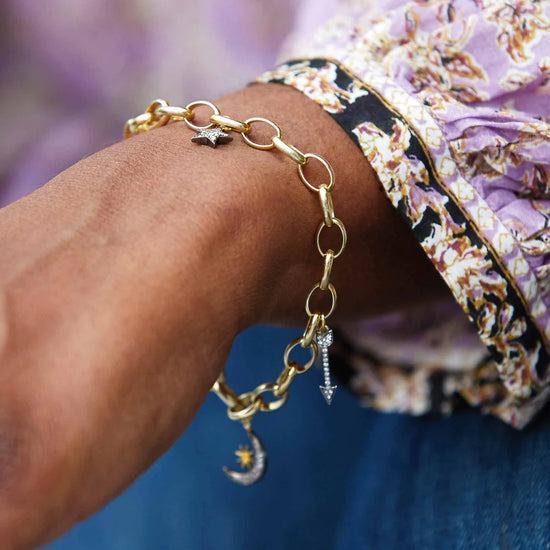 Gold pendant bracelet with oval belcher chain and pave diamond star arrow and moon pendants