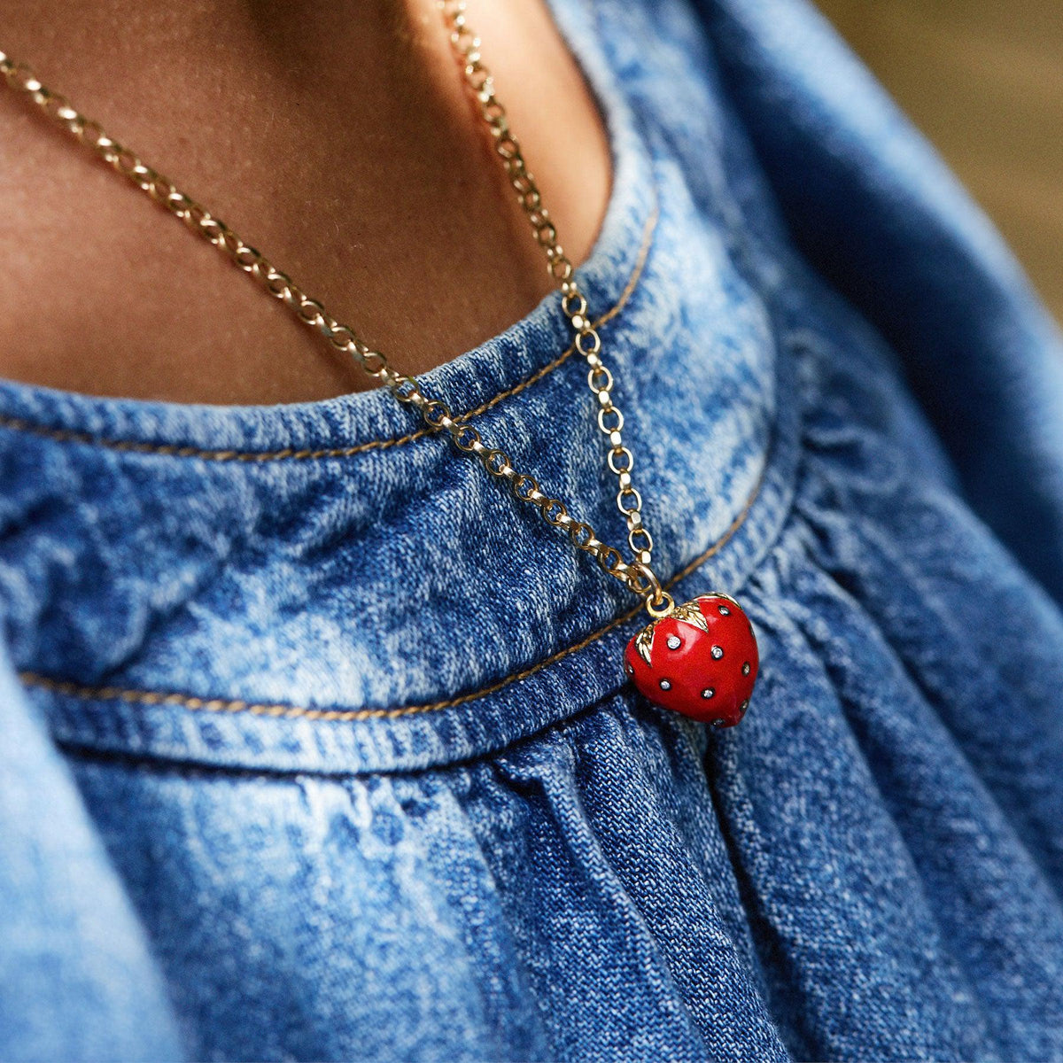 red enamel strawberry studded with diamonds necklace on a gold chain