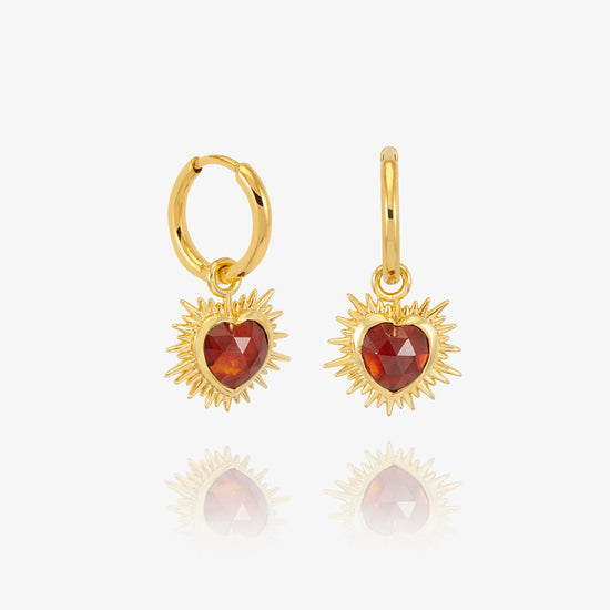 gold spiky heart shaped charm earrings with red stone and huggie hoops from rachel jackson