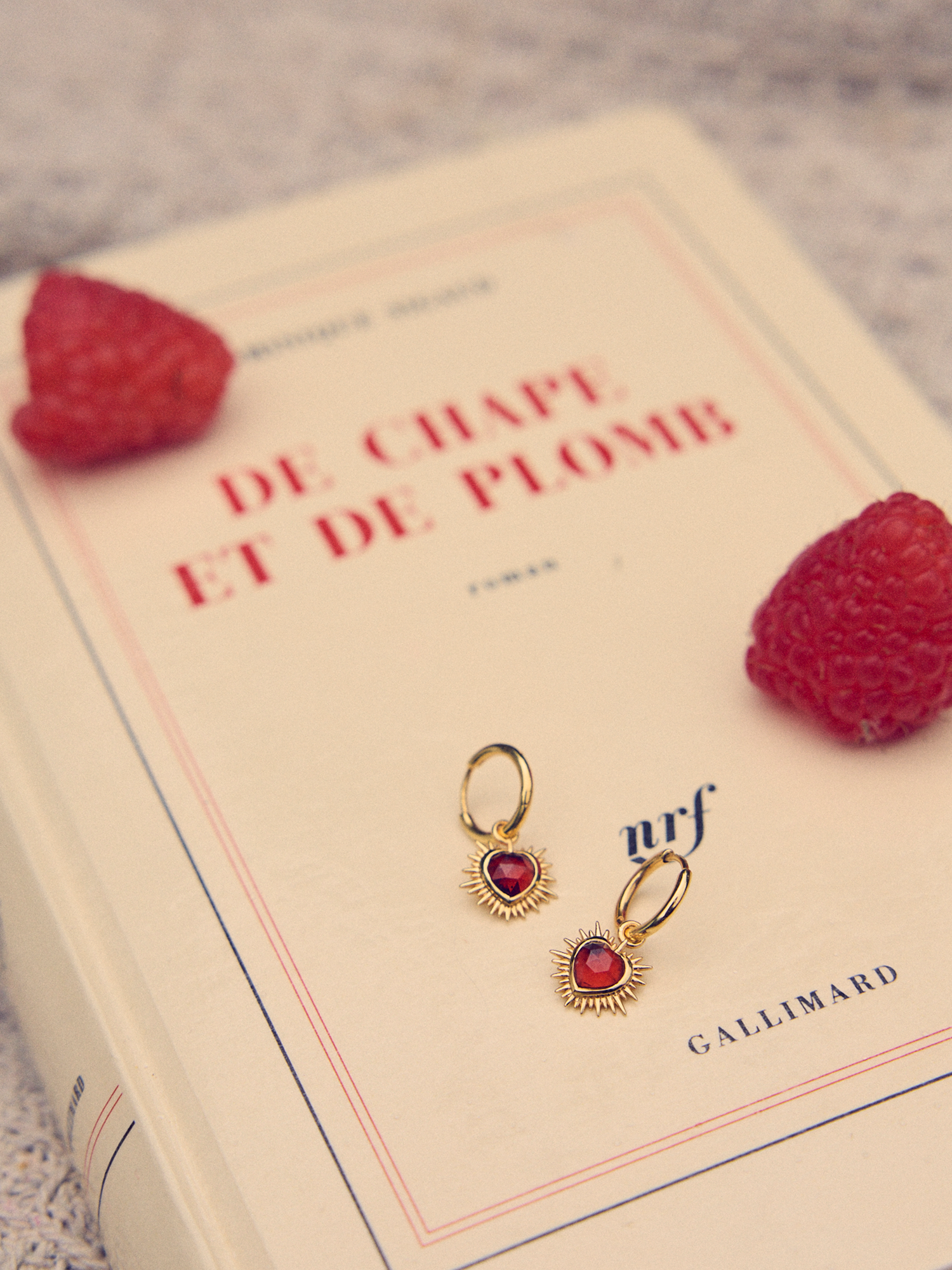 gold spiky heart shaped charm earrings with red stone and huggie hoops from rachel jackson 