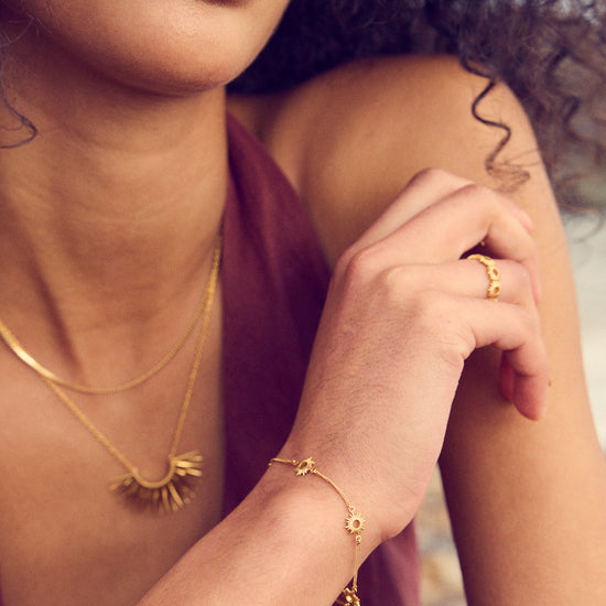 gold bracelet with mini sunshines places along the chain from rachel jackson model shot