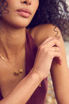 gold bracelet with mini sunshines places along the chain from rachel jackson model shot