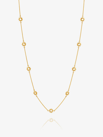 Gold necklace with sUN-shaped detail on a white background