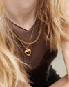 gold heart with red stone inside on a gold chain from rachel jackson model shot