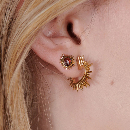 small spiky gold heart stud earrings with red stone inside and butterfly clasp from rachel jackson model shot