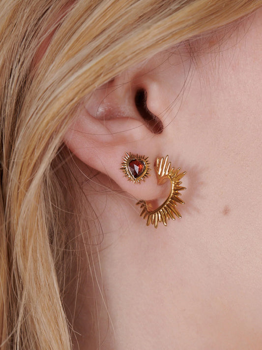 small spiky gold heart stud earrings with red stone inside and butterfly clasp from rachel jackson model shot