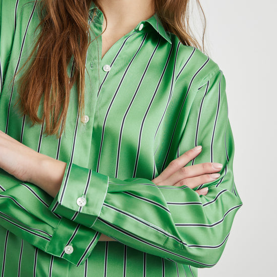 Close up view of button on the Elias stripe shirt in basil green.