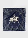 A square navy blue scarf featuring a white equestrian design in the center and an ornate border of horseshoes, dots, and decorative motifs, laid flat on a light gray background.