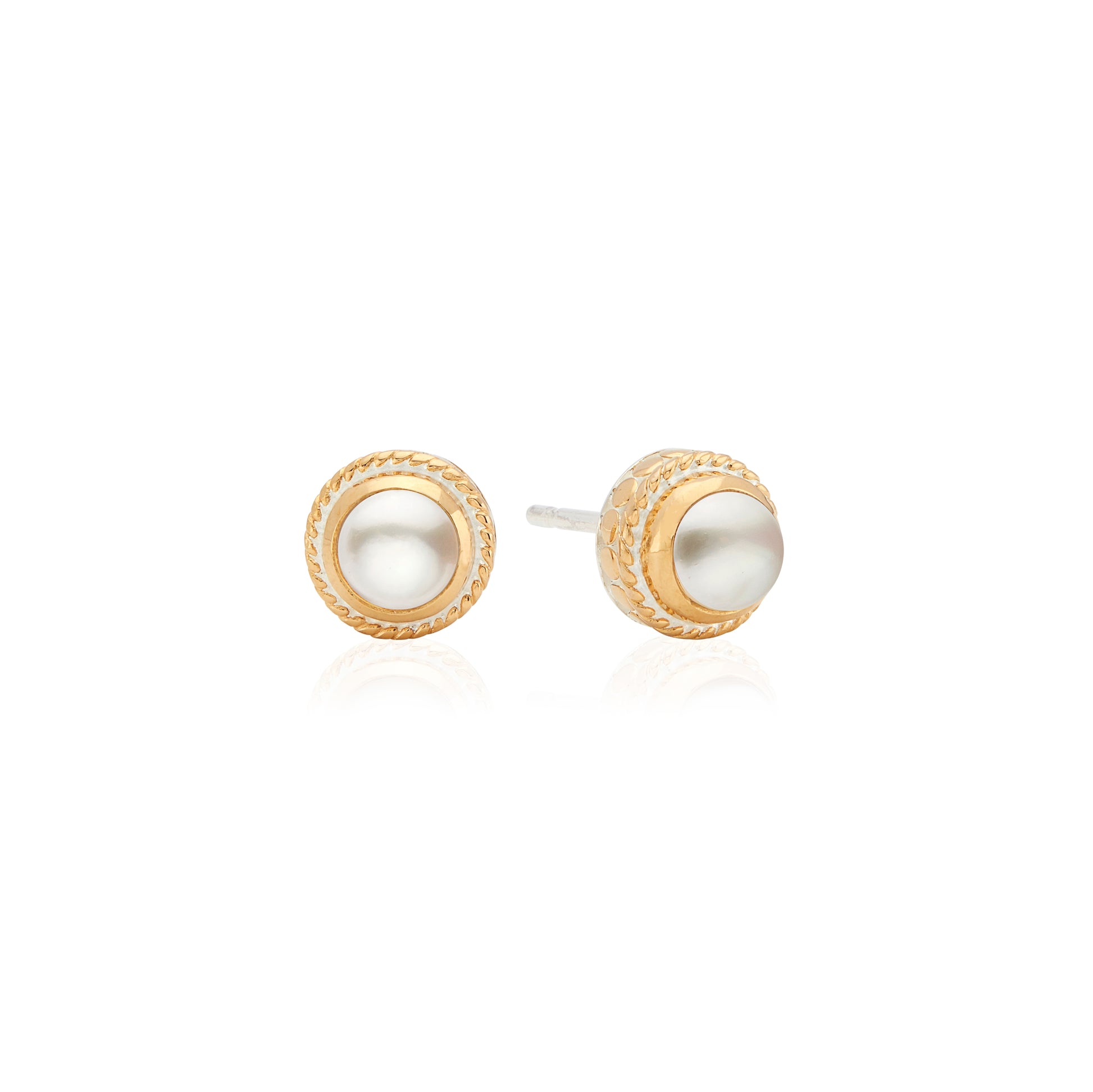 Pair of gold and pearl stud earrings on a white background from Anna Beck
