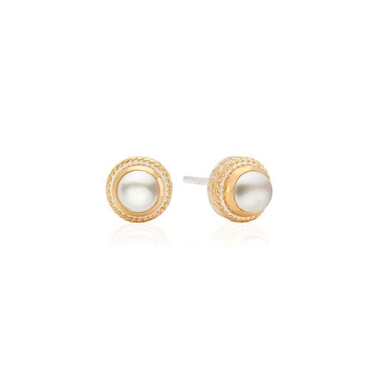 Pair of gold and pearl stud earrings on a white background from Anna Beck