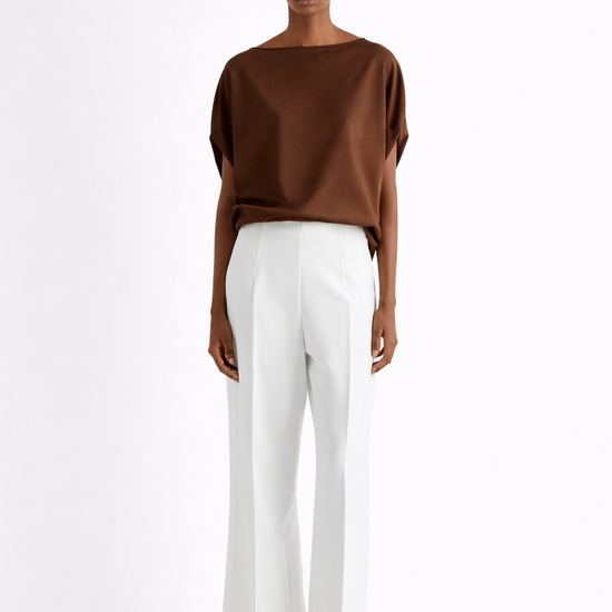 Person wearing a brown top and white pants on a white background from Mei MeiJ