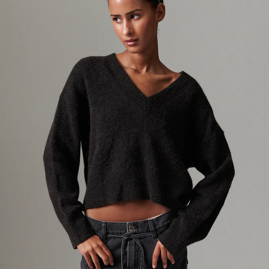v neck jumper dark brown wool jumper with rib detailing and oversized fit model shot