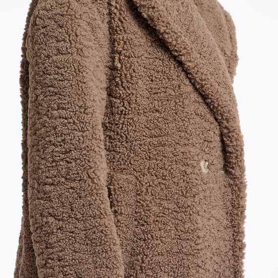 brown teddy bear fur mid length coat with single button closure and collar/lapel side view