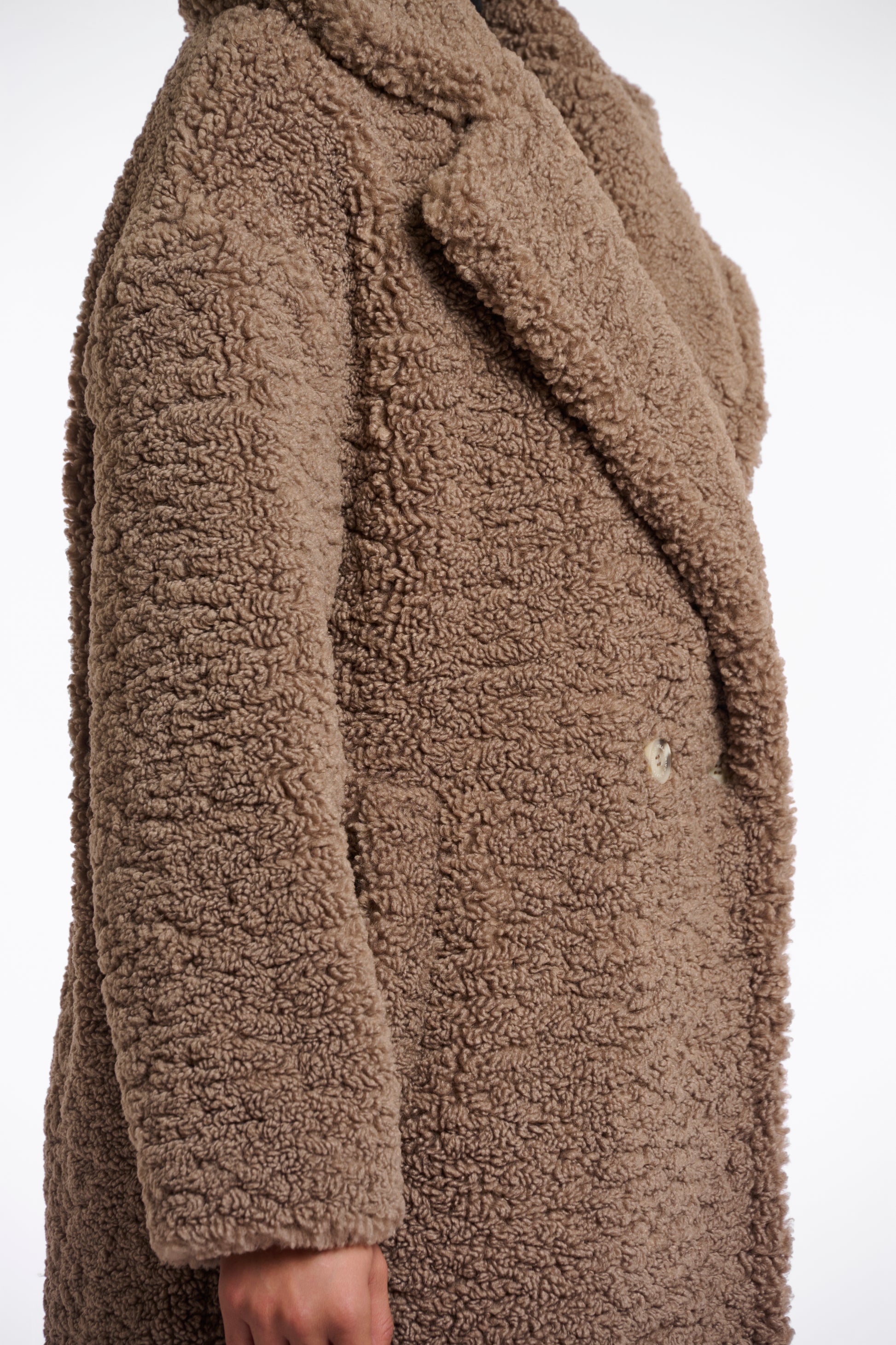 brown teddy bear fur mid length coat with single button closure and collar/lapel side view