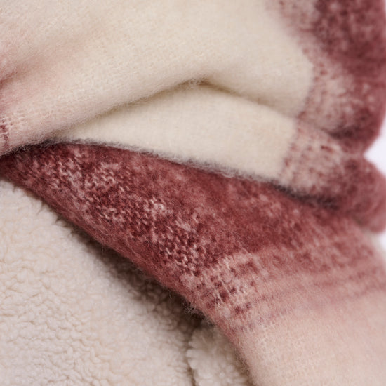 Close-up of textured fabric in pink and beige colors.