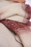 Close-up of textured fabric in pink and beige colors.
