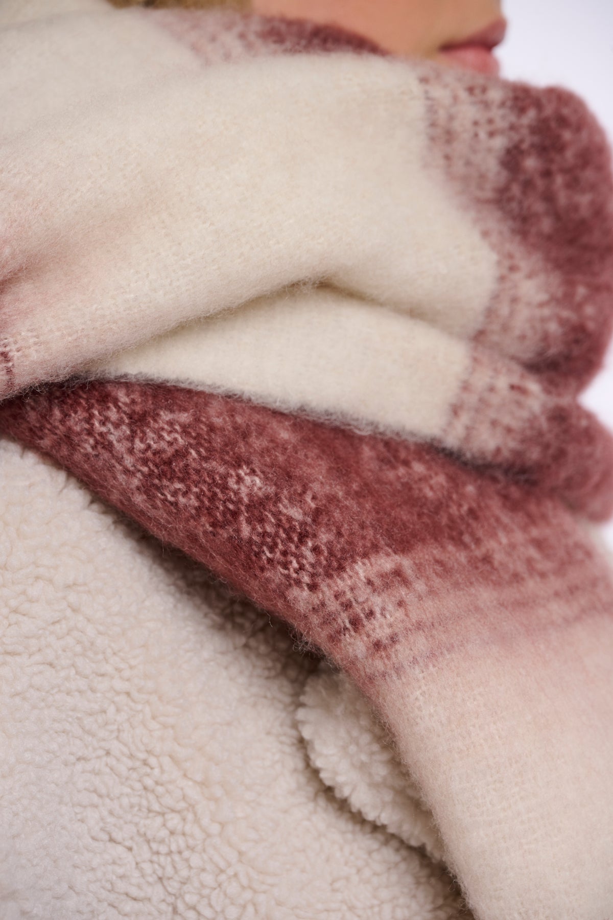 Close-up of textured fabric in pink and beige colors.
