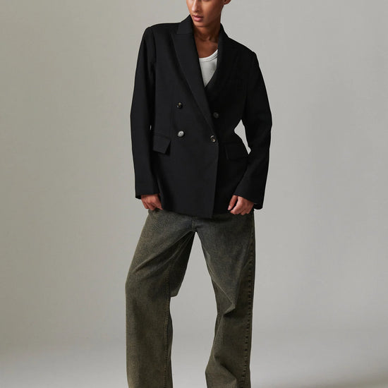 double breasted oversized black blazer with notch lapel and flap pockets  model shot