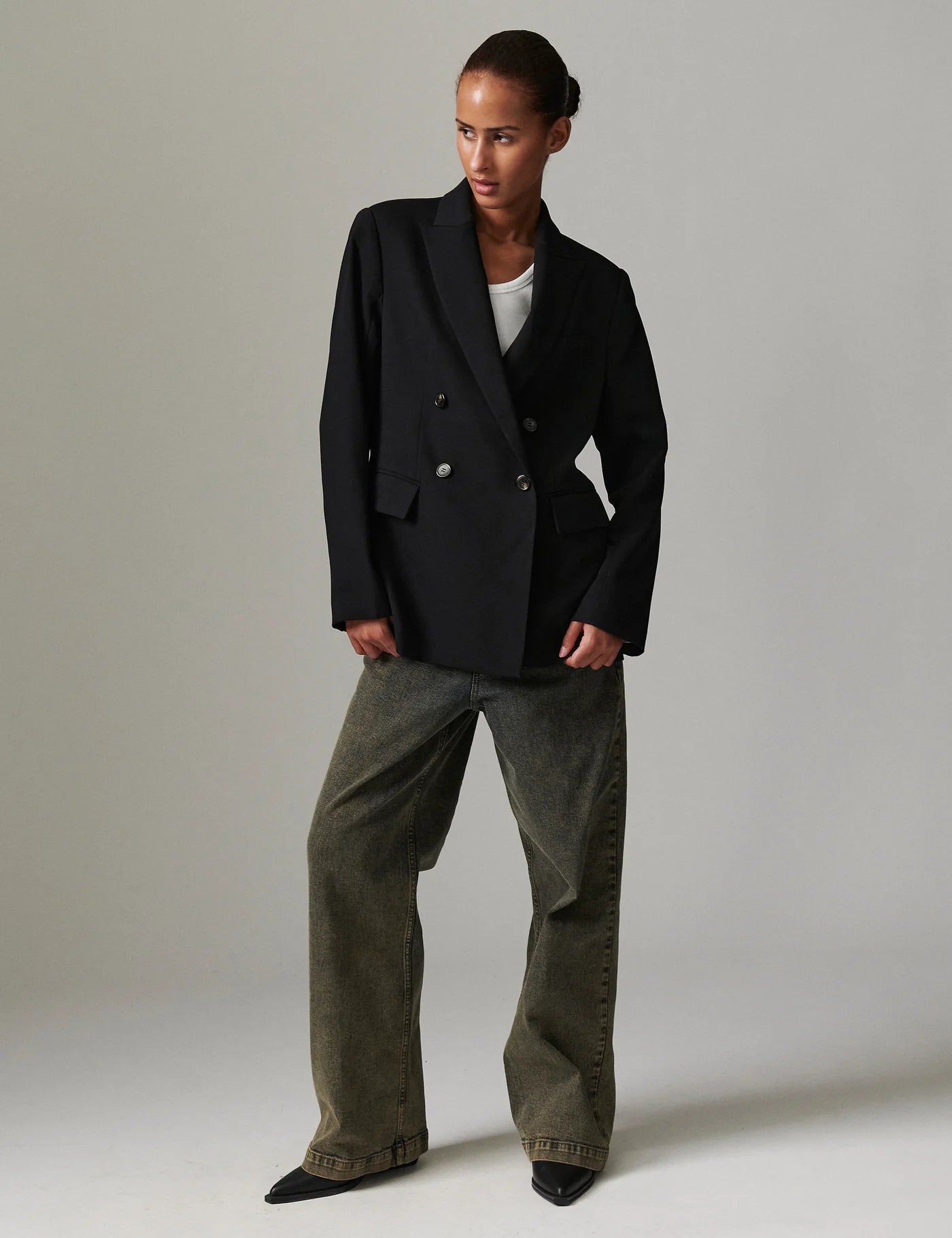 double breasted oversized black blazer with notch lapel and flap pockets  model shot