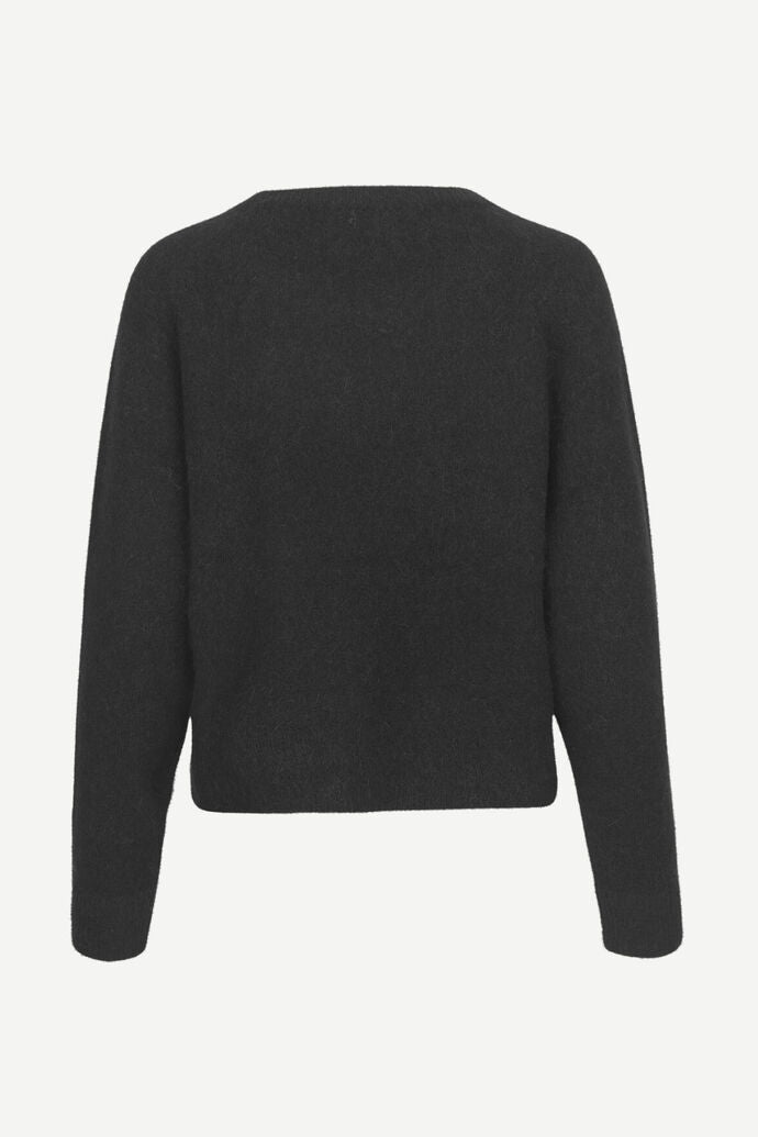 Wide crew neck black knitted jumper with long sleeves and a waist length