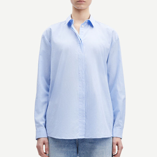 Light blue cotton shirt with long sleeves and full length hidden placket with button fastening