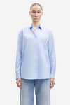 Light blue cotton shirt with long sleeves and full length hidden placket with button fastening