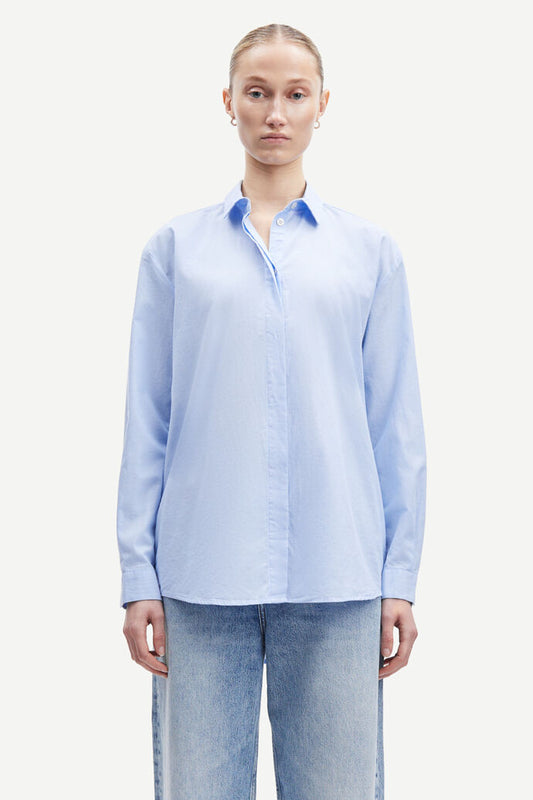 Light blue cotton shirt with long sleeves and full length hidden placket with button fastening