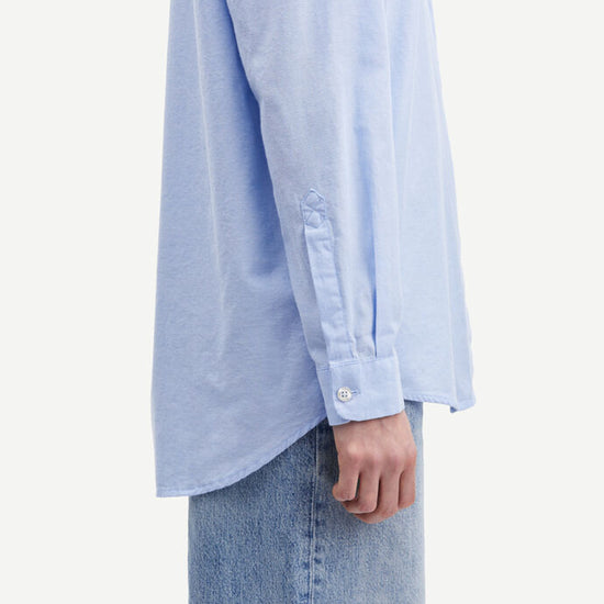 Light blue cotton shirt with long sleeves and full length hidden placket with button fastening