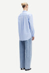 Light blue cotton shirt with long sleeves and full length hidden placket with button fastening