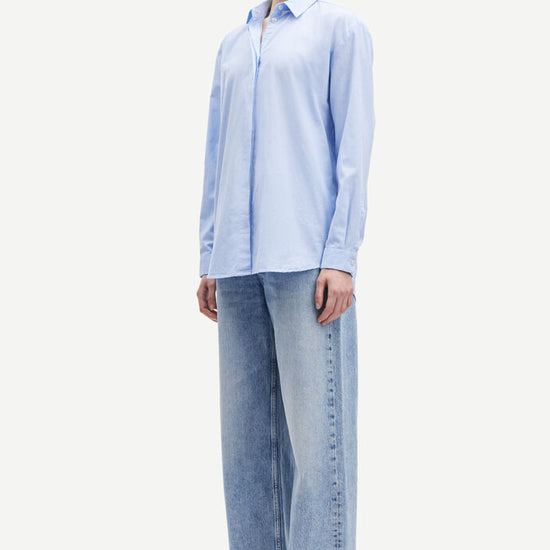 Light blue cotton shirt with long sleeves and full length hidden placket with button fastening