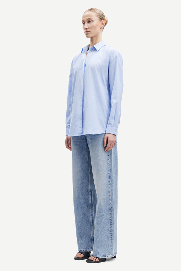 Light blue cotton shirt with long sleeves and full length hidden placket with button fastening