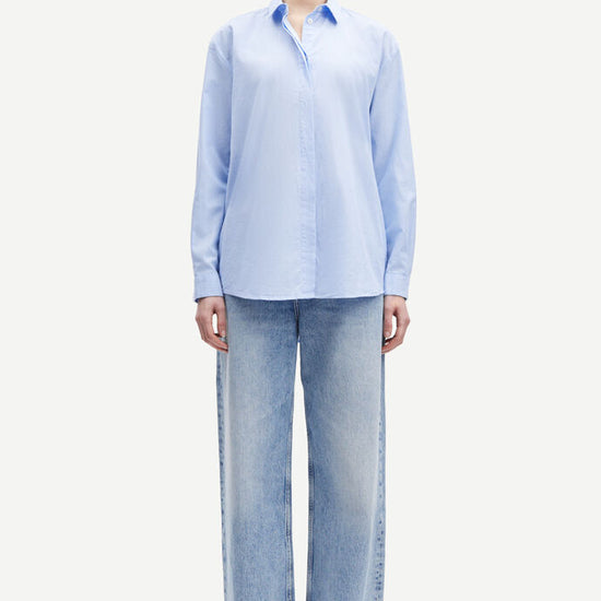 Light blue cotton shirt with long sleeves and full length hidden placket with button fastening