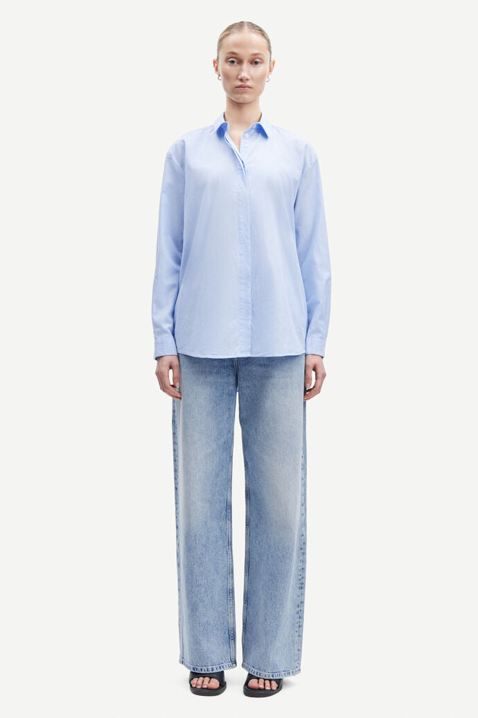 Light blue cotton shirt with long sleeves and full length hidden placket with button fastening