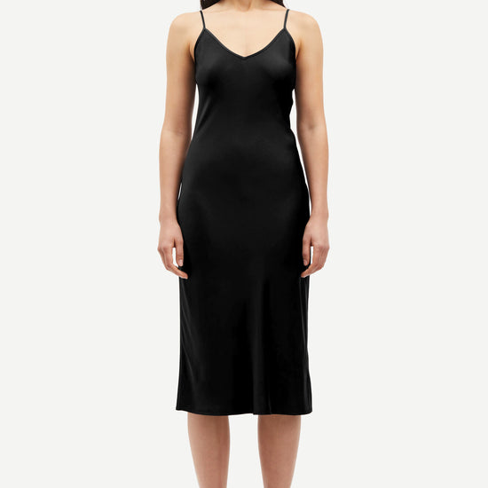 Black slip dress with adjustable straps and V neck and backline