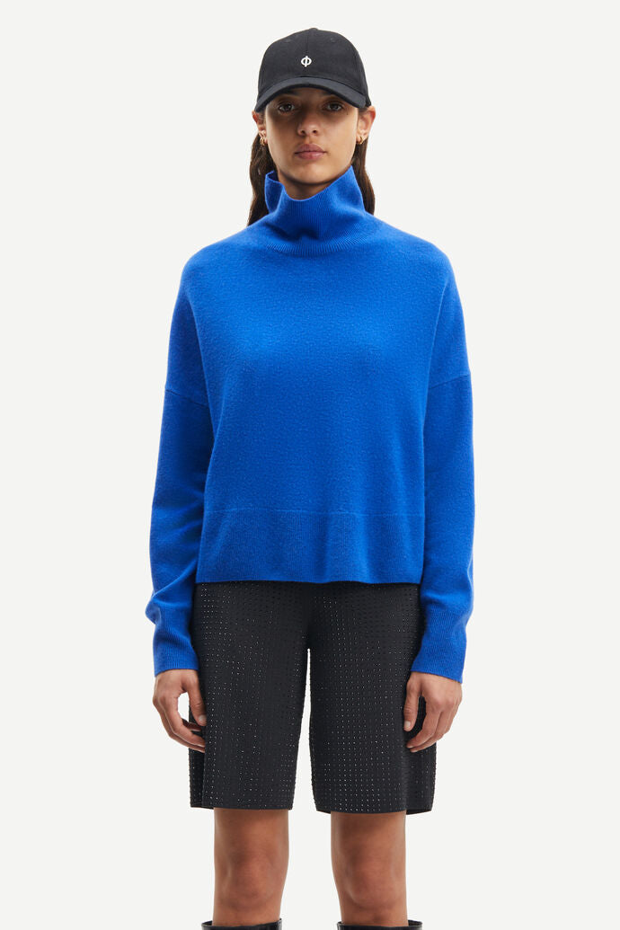 Bright blue turtleneck cashmere long sleeved jumper with dropped shoulders