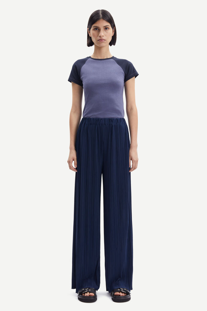Navy blue wide leg trousers with elasticated waist and a crinkle effect fabric