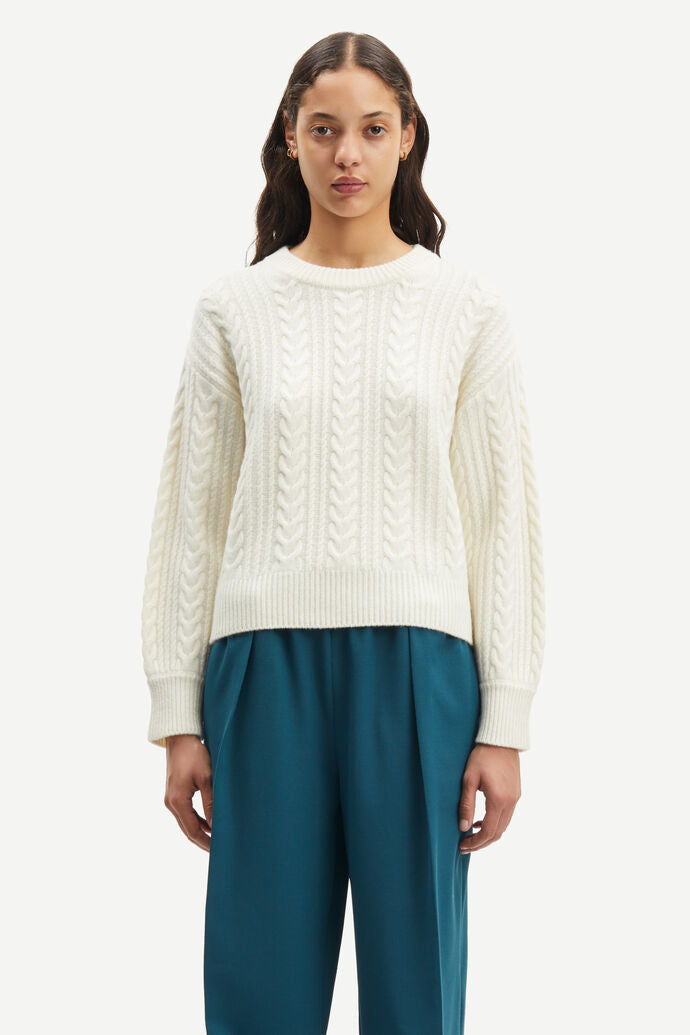 Crew neck cable knit wool jumper in ecru with dropped shoulders and ribbed cuffs