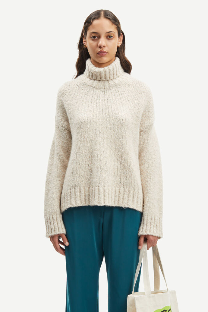 Ecru relaxed fit turtleneck jumper with deep ribbed collar cuffs and hem and dropped shoulders