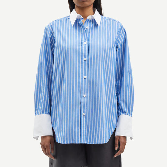 Blue and white vertical striped shirt with classic shirt features and white cuffs and collar