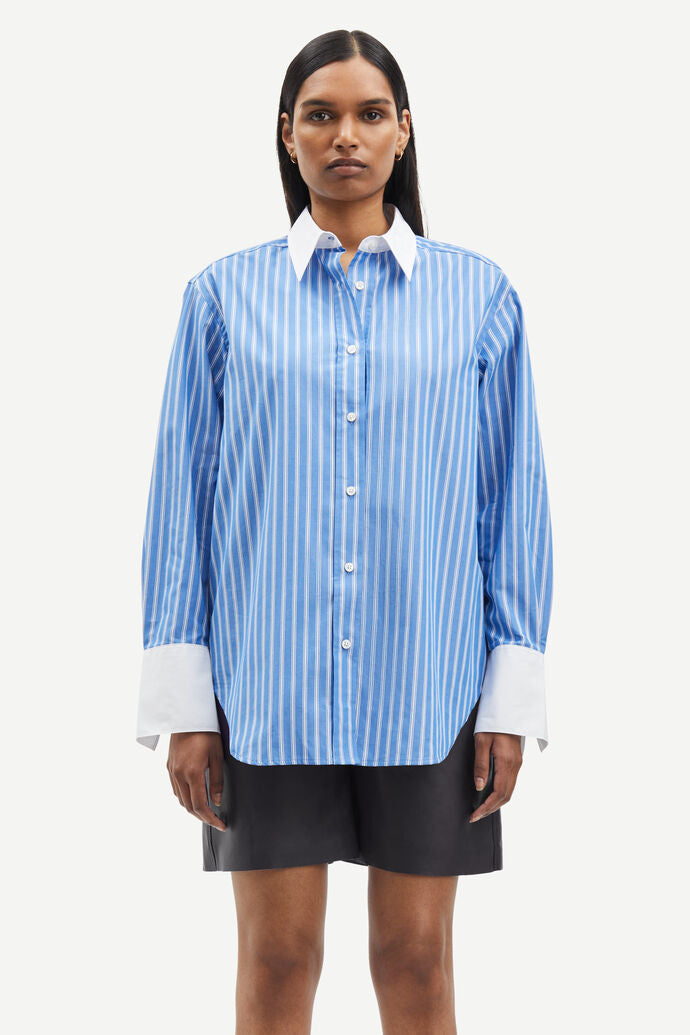 Blue and white vertical striped shirt with classic shirt features and white cuffs and collar