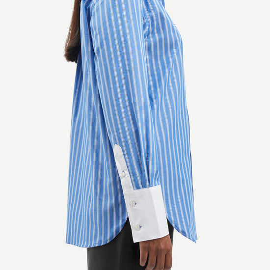 Blue and white vertical striped shirt with classic shirt features and white cuffs and collar