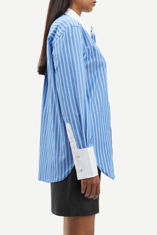 Blue and white vertical striped shirt with classic shirt features and white cuffs and collar