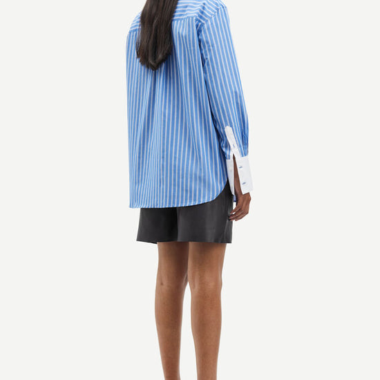 Blue and white vertical striped shirt with classic shirt features and white cuffs and collar