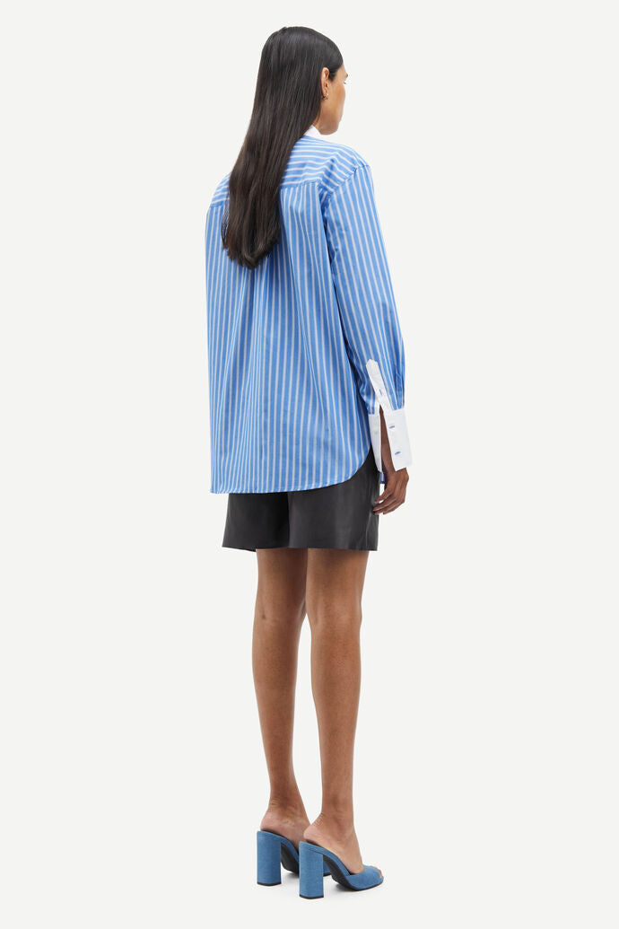 Blue and white vertical striped shirt with classic shirt features and white cuffs and collar