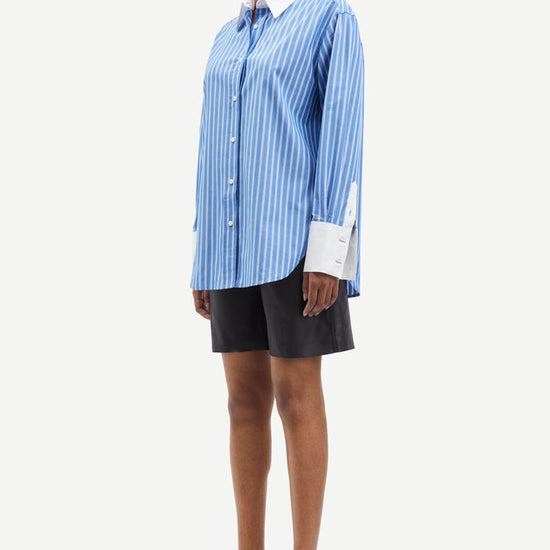 Blue and white vertical striped shirt with classic shirt features and white cuffs and collar