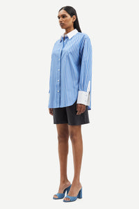 Blue and white vertical striped shirt with classic shirt features and white cuffs and collar