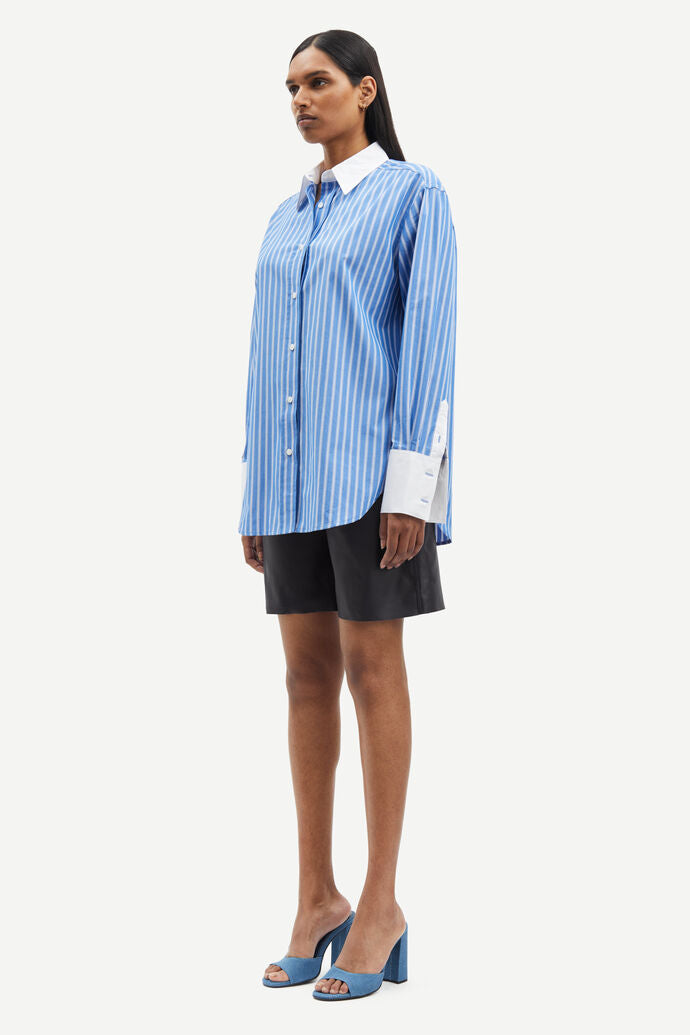 Blue and white vertical striped shirt with classic shirt features and white cuffs and collar