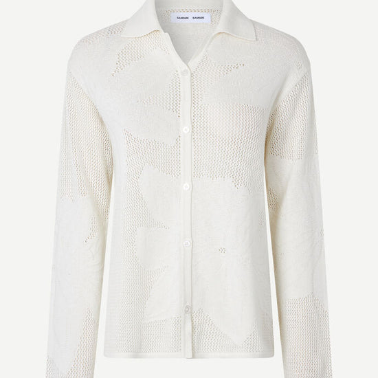 Collared button through knit shirt with floral design within the weave