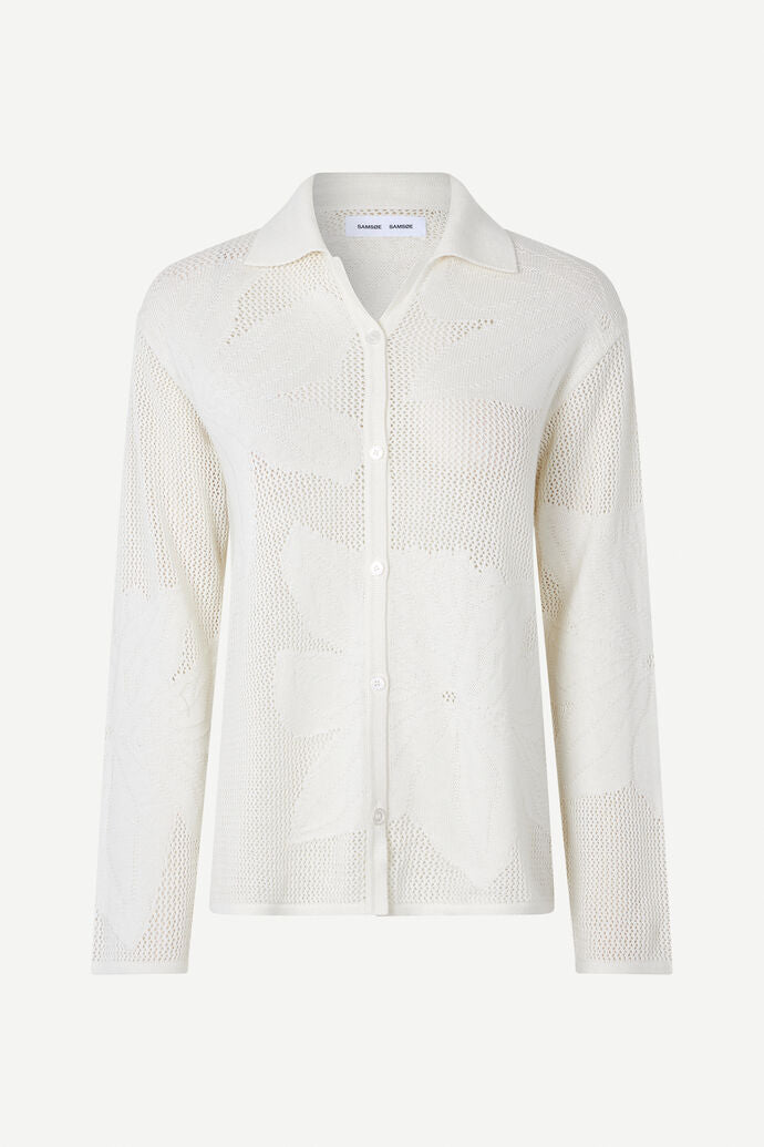 Collared button through knit shirt with floral design within the weave