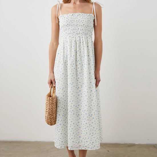 Thin strapped summer dress in white with ditsy florals and a ruched bodice midi in length